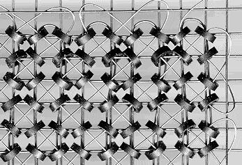 Ferrite beads of a classic core memory with write and read wires, Photo: ZDV